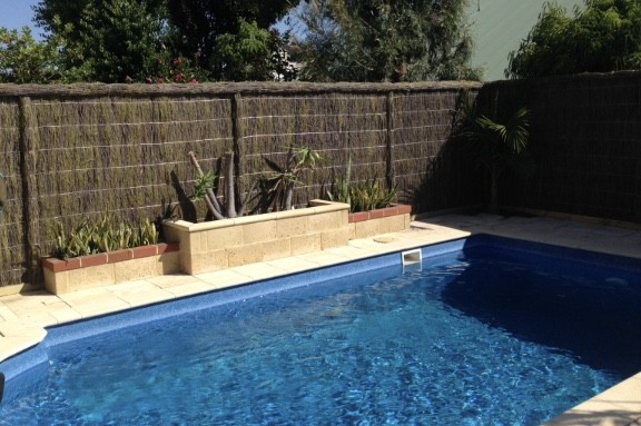 Brians Brushwood Fencing Perth.  Natural fence hand built for the perfect pool fence and property border.  Custom gates to give that landscape design and look